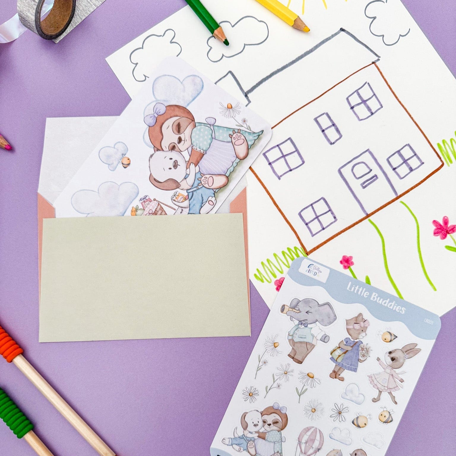 Child enjoying creative playtime with Dolly and Fred's cute character stationery set, featuring illustrated postcards, envelopes, stickers, crayons, and drawing accessories
