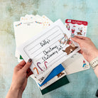 Christmas stationery set with cards and envelopes on a textured surface