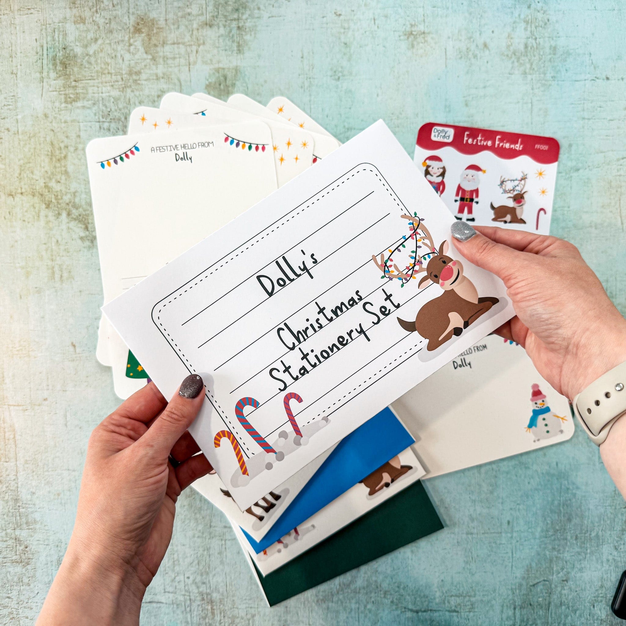 Christmas stationery set with cards and envelopes on a textured surface