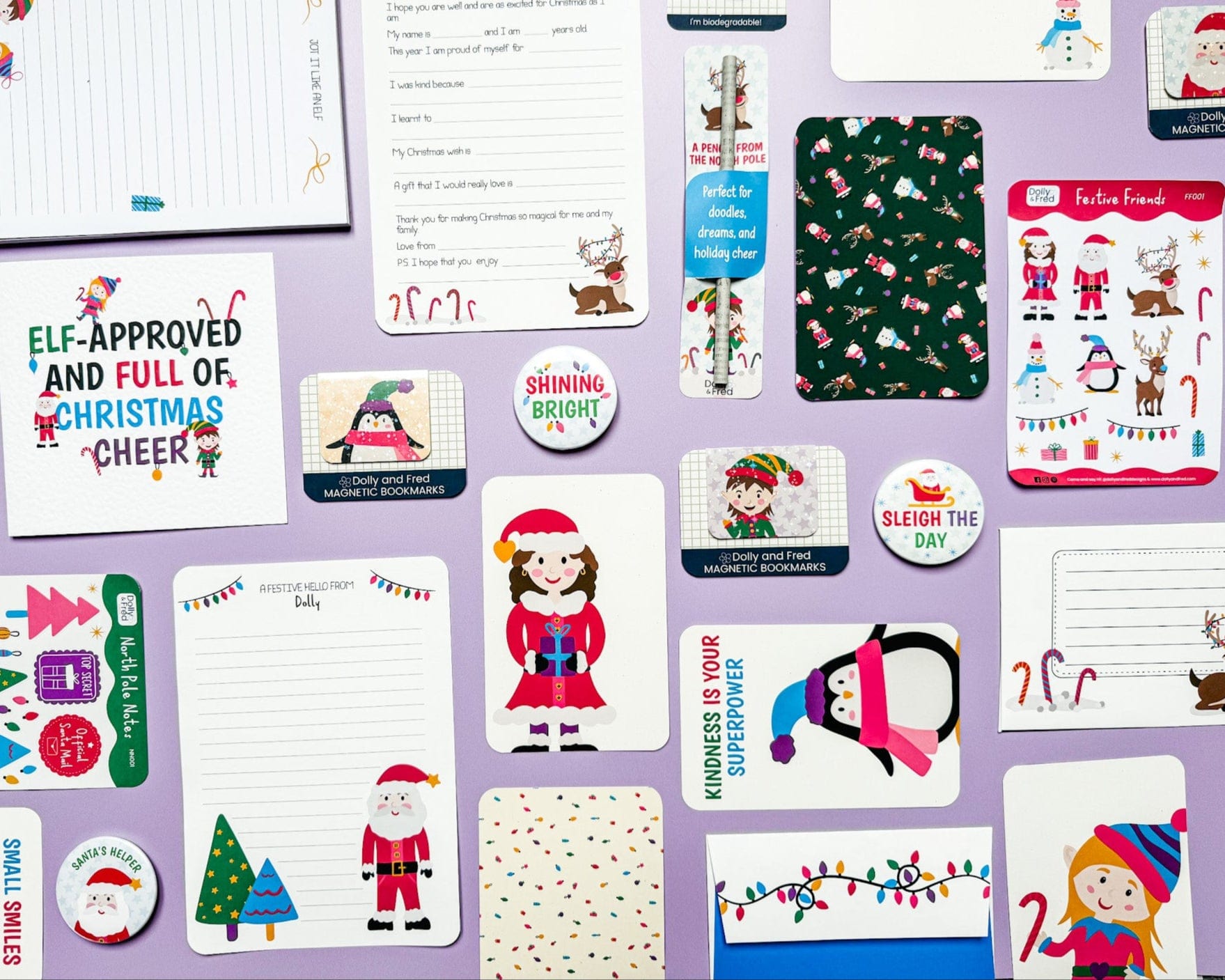 Collection of Christmas-themed stationery items on a purple background