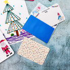 Childrens christmas themed postcards and envelopes in a flatlay