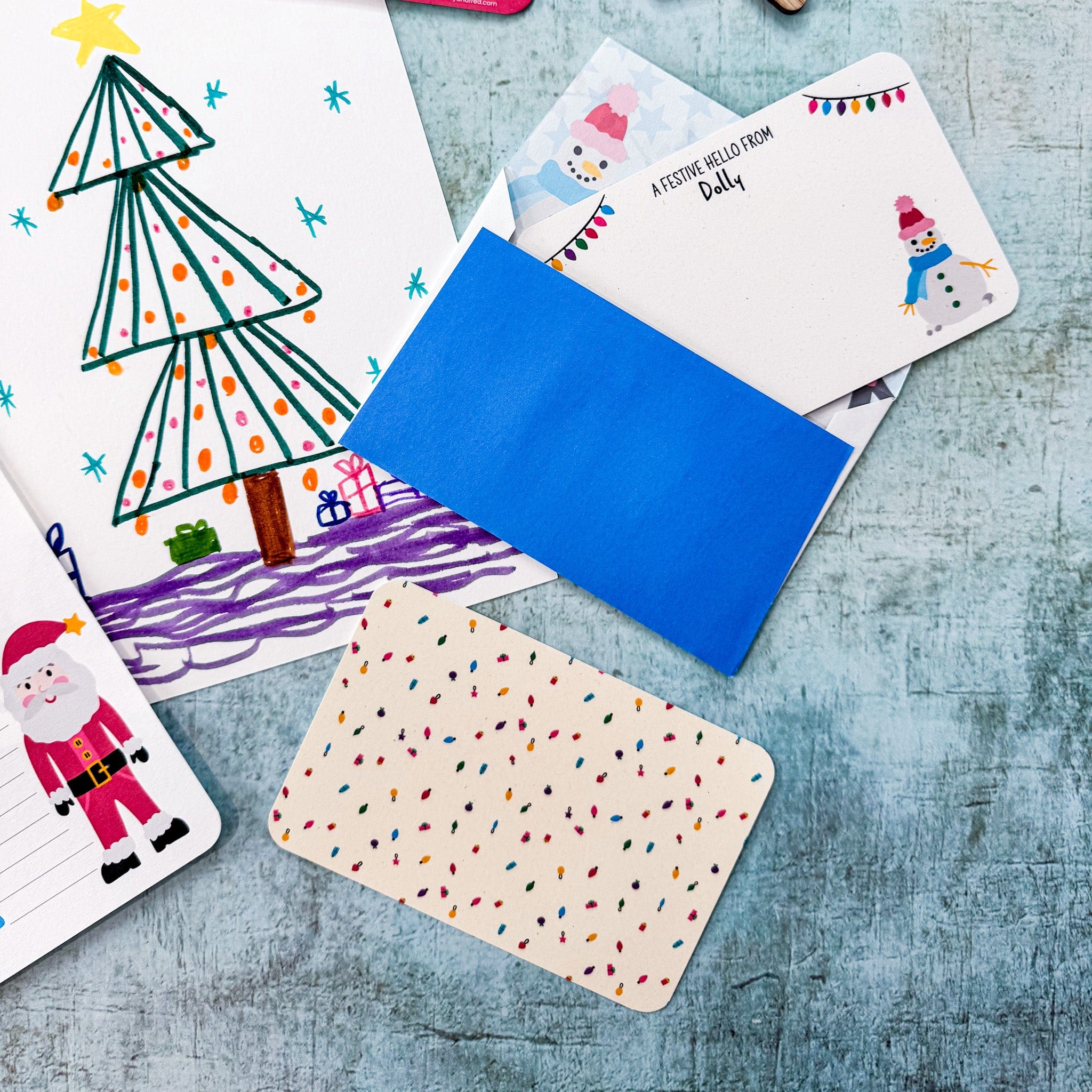 Childrens christmas themed postcards and envelopes in a flatlay