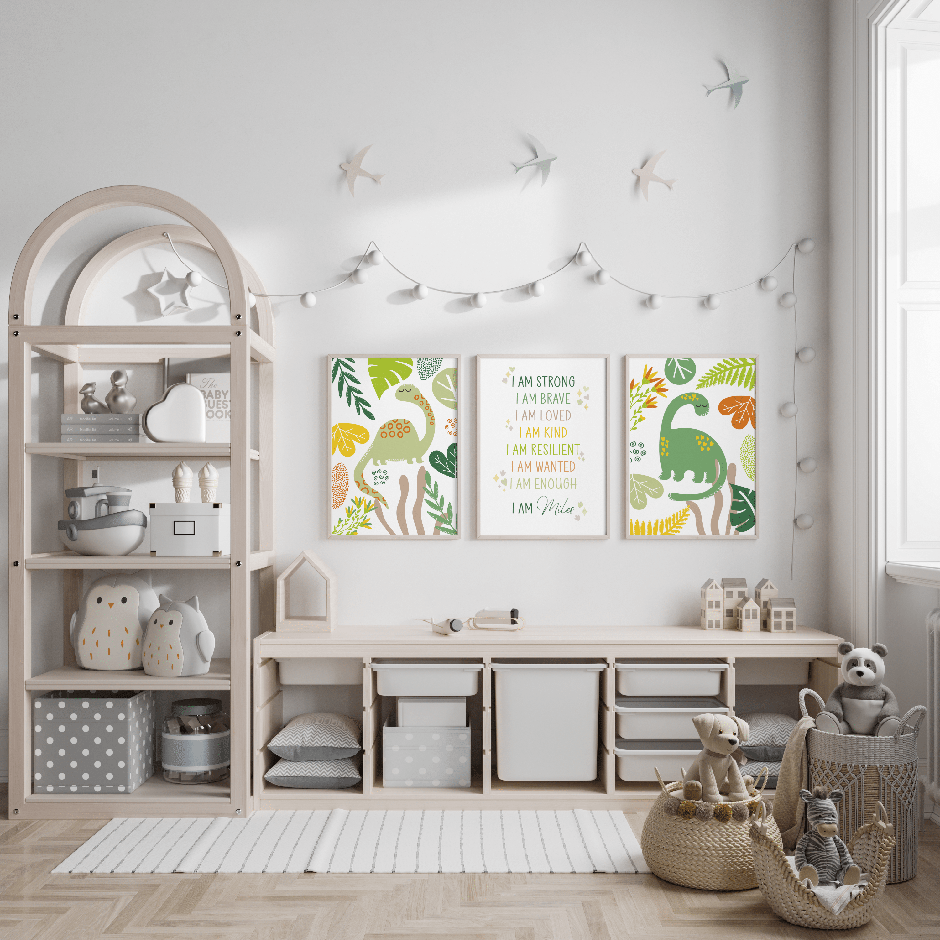 Set of 3 green dinosaur and personalised affirmation prints displayed above storage in a bright child's room.