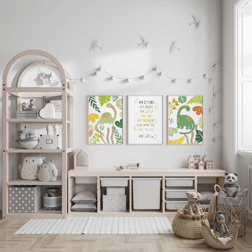 Set of 3 green dinosaur and personalised affirmation prints displayed above storage in a bright child's room.