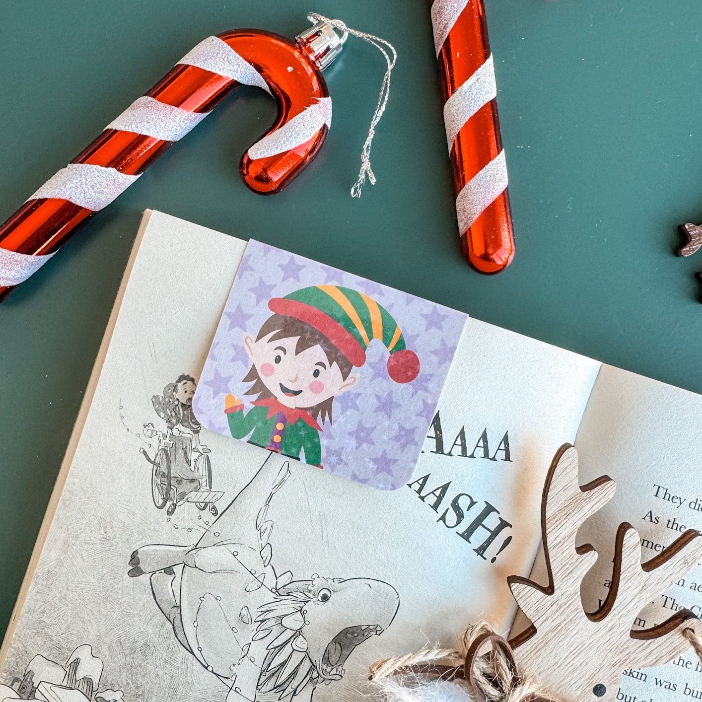 Elf themed magnetic bookmark surrounded by christmas decorations
