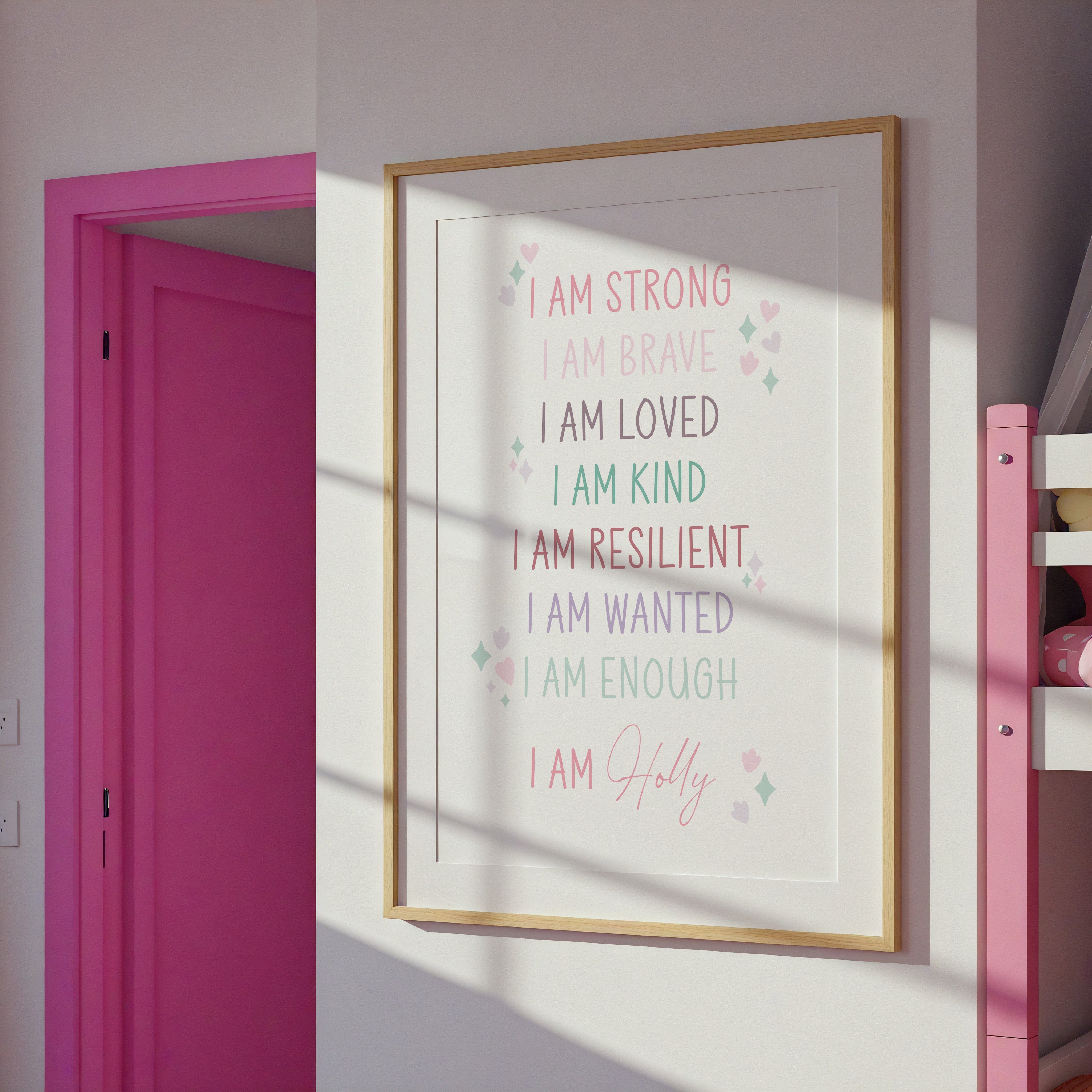 Personalised affirmation print in a pink-walled room with sunlight, showing its vibrant colors and framed in pink.