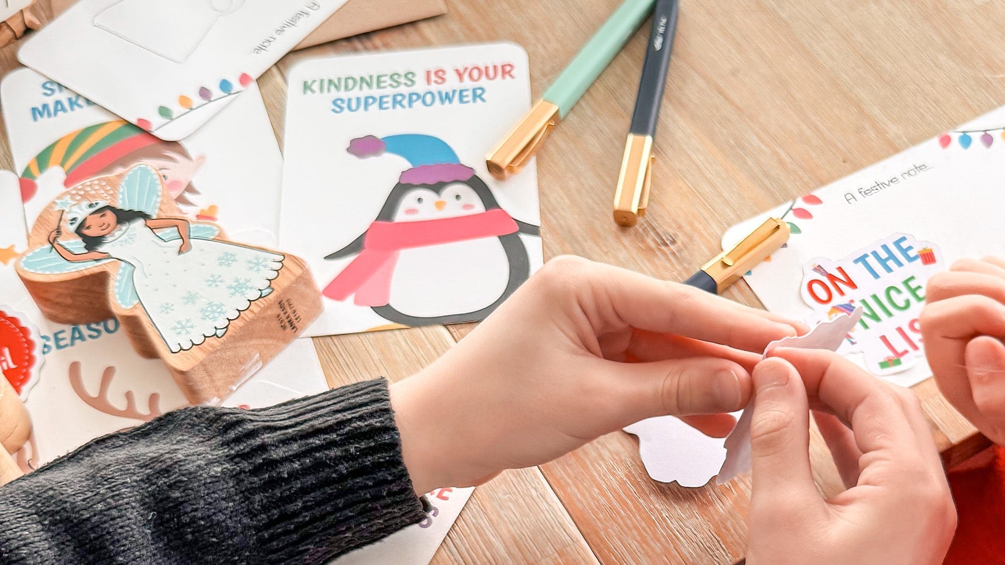 Children's hands with craft materials on a wooden table