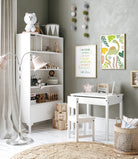 Dinosaur print trio with motivational quote styled in a white kids’ play area with chairs and shelves.
