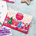 A festive envelope decorated with lots of christmas stickers