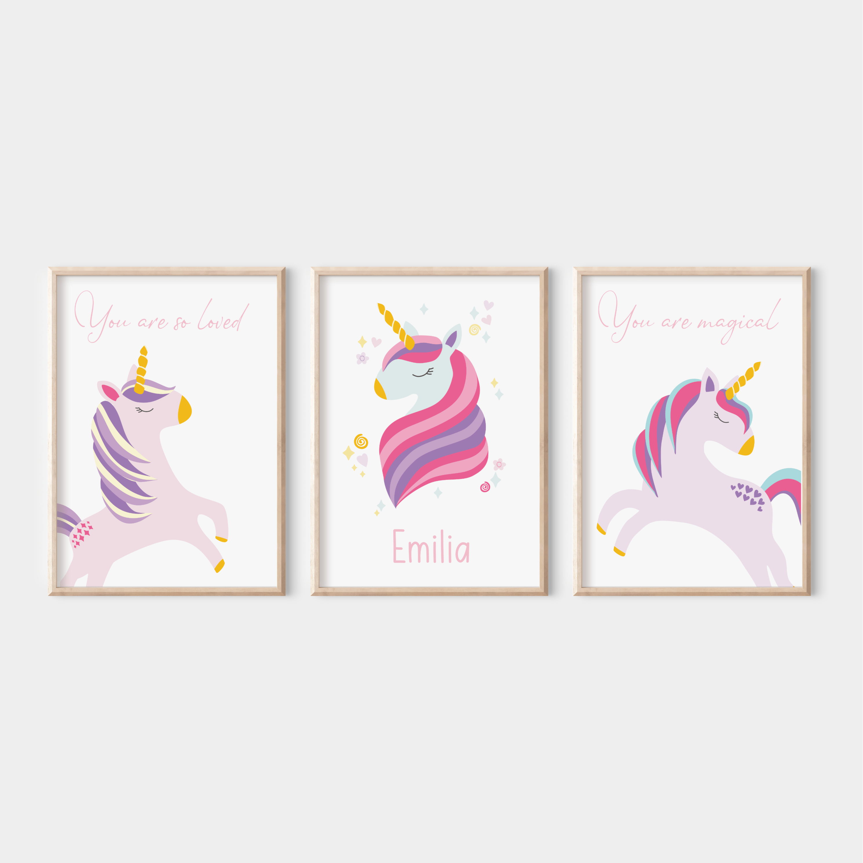 Set of 3 framed unicorn prints on a white wall – includes personalised name print and two affirmation prints with whimsical unicorn illustrations in soft pastel tones