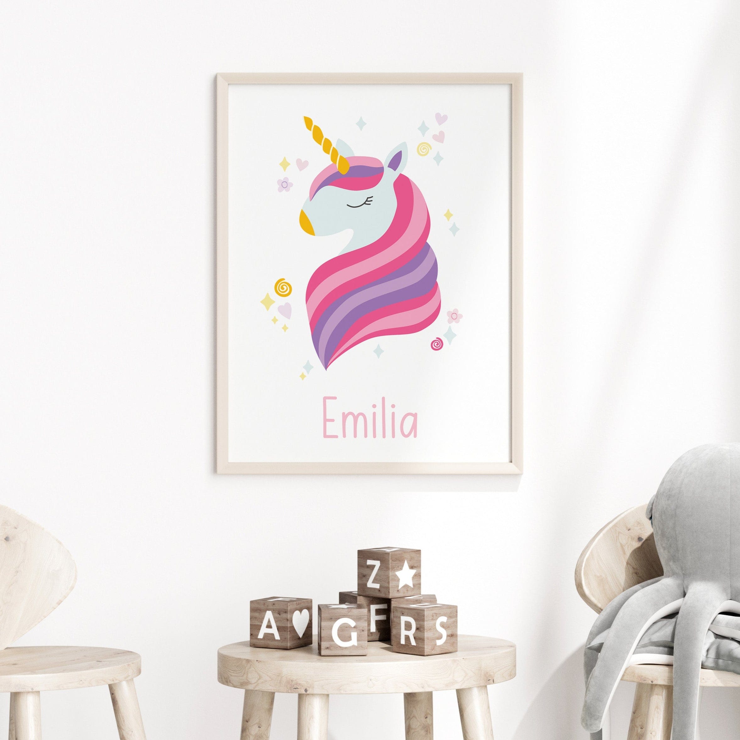 Personalised unicorn name print framed and displayed on a pastel-themed children’s bedroom wall – custom kids wall art by Dolly and Fred