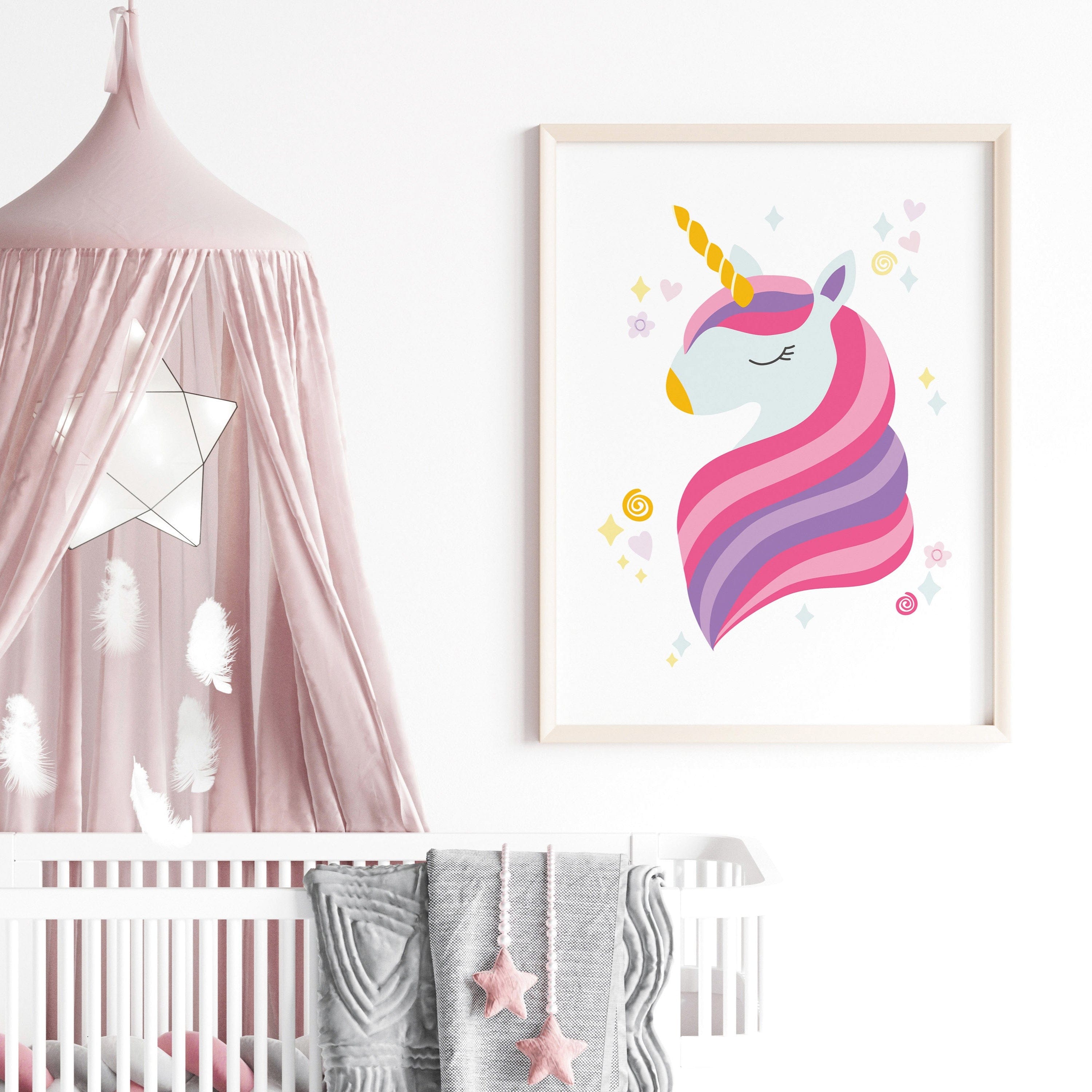 Framed unicorn print in a girl’s room setting with stars and pastels – ideal for unicorn-themed bedroom decor