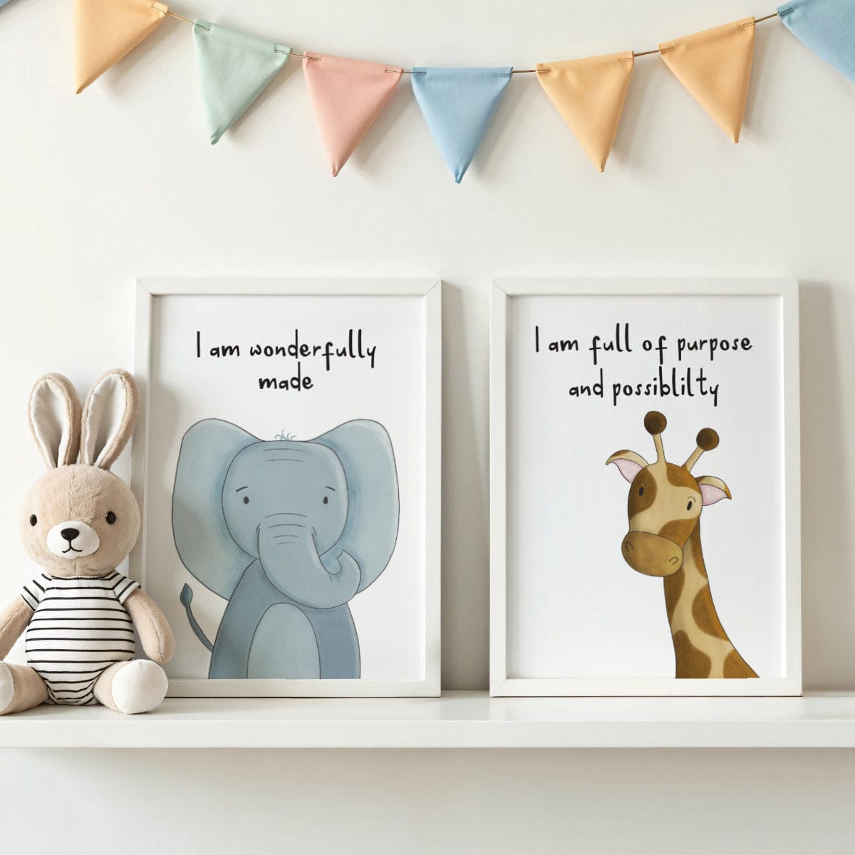 Children's room decor with framed animal illustrations and motivational quotes, accompanied by a plush toy and colorful banner.