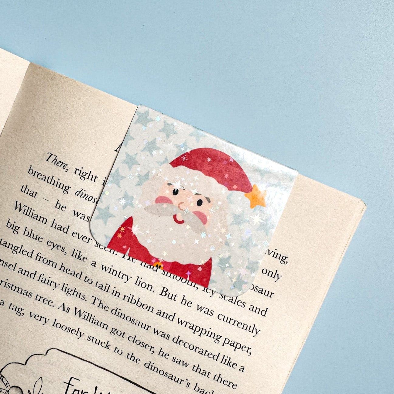 Book with a Santa Claus bookmark on a blue background