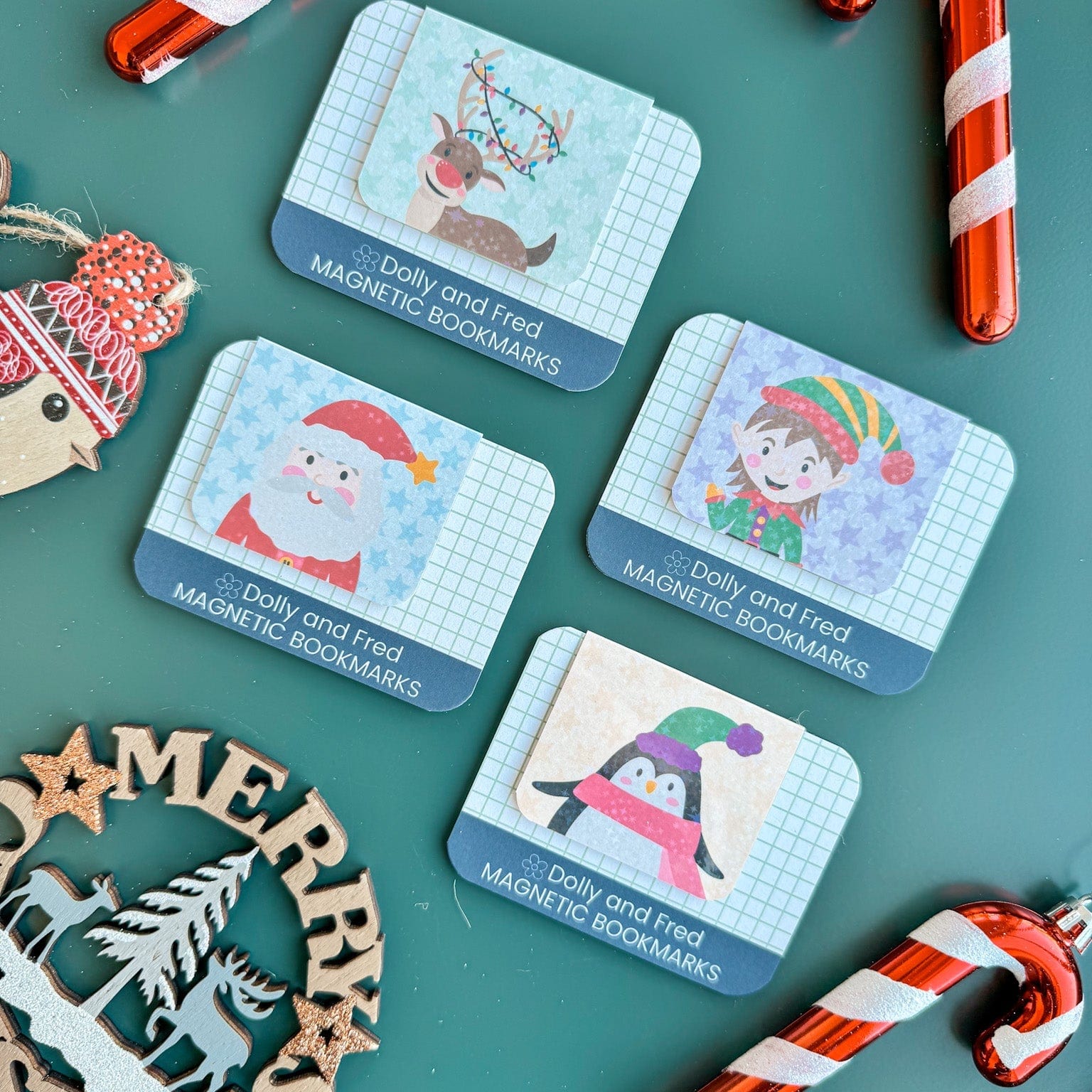 Set of Christmas-themed bookmarks with cartoon characters on a green background with candy canes.