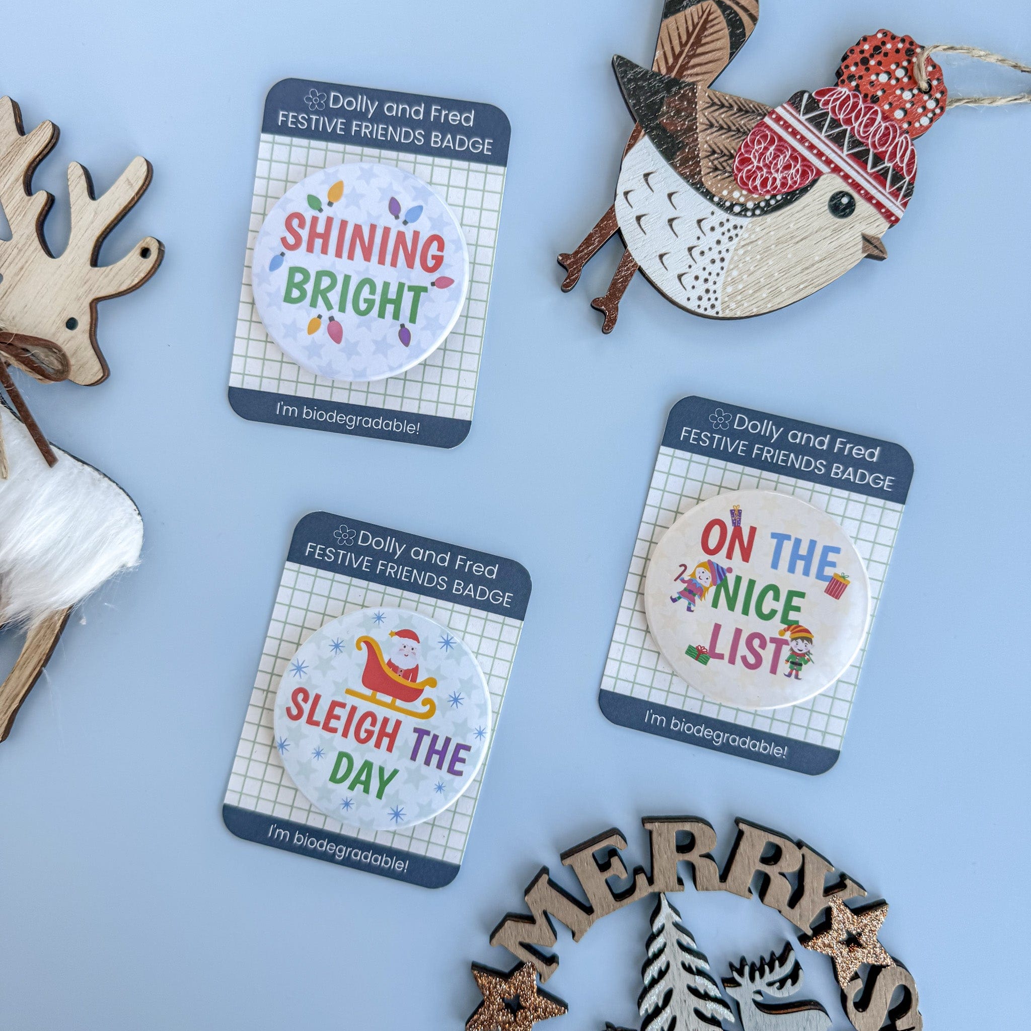 Christmas-themed badges with festive sayings on blue background