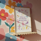 Framed adventure writing prompt print for kids on a playful floral wall, perfect for bright writing corners.