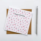 Square greetings card featuring cherry pattern and kraft envelope