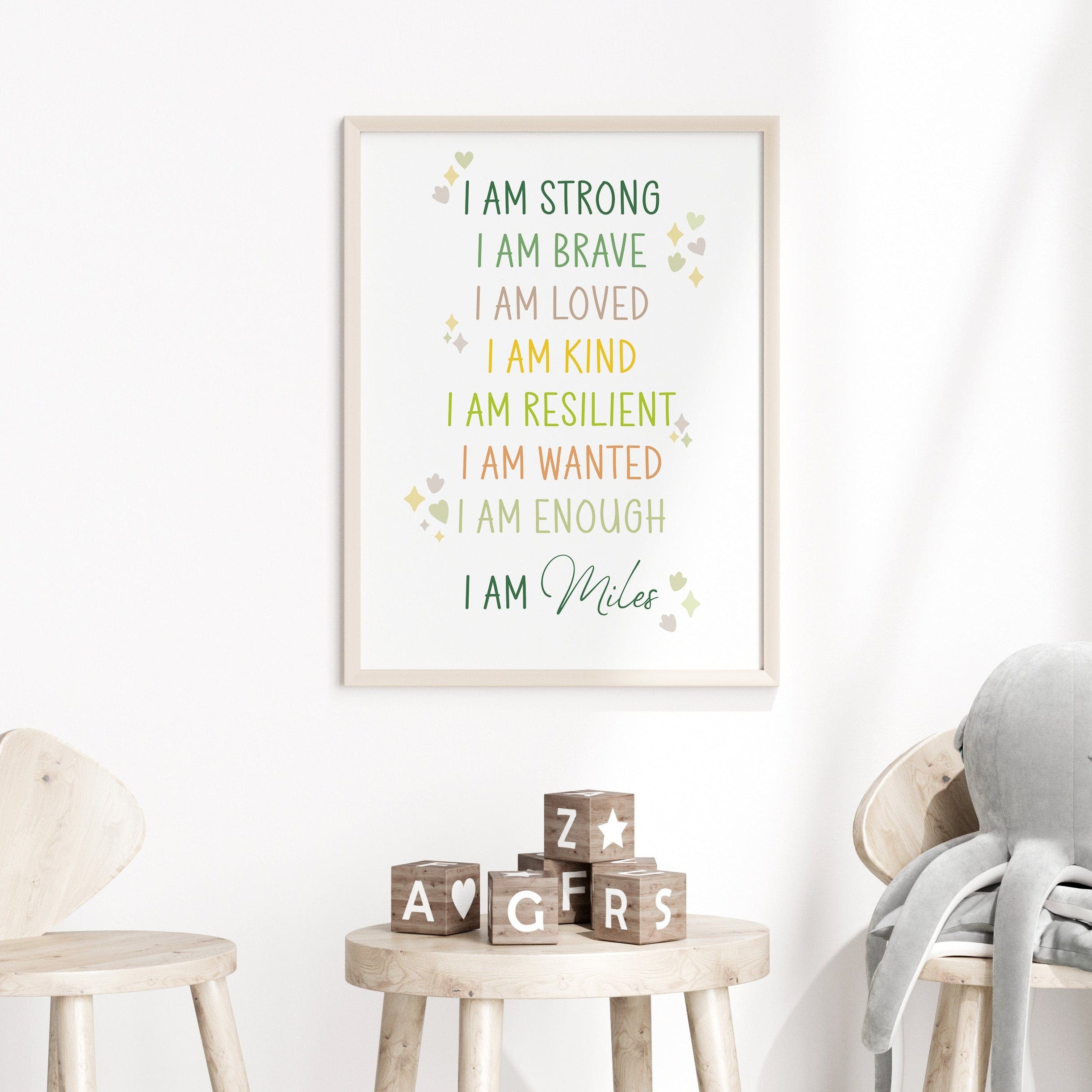 Personalised "I AM" print leaning against a wall with a small table and decor, illustrating how it can be displayed.