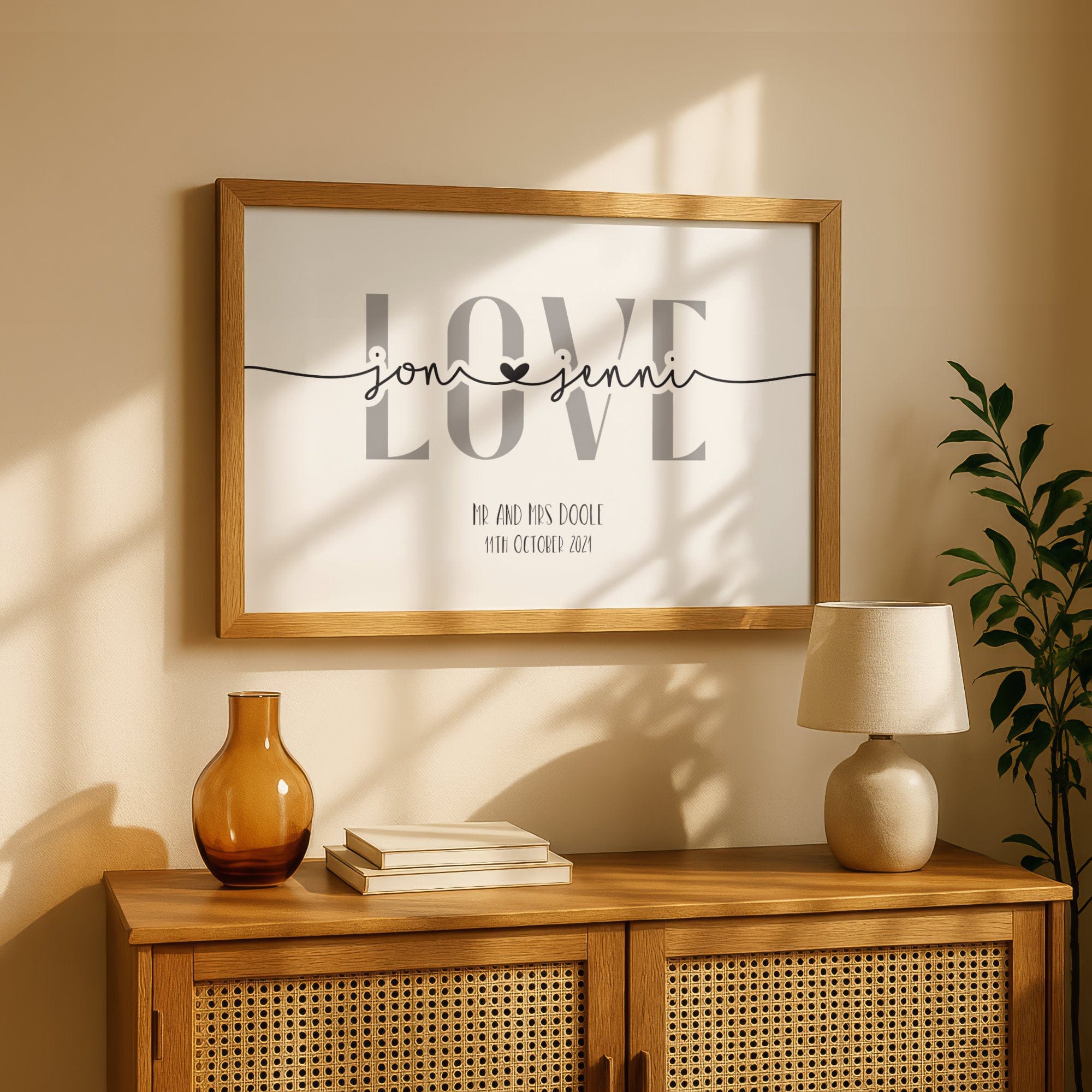 Framed 'LOVE' sign on a wall above a wooden cabinet with decor items.