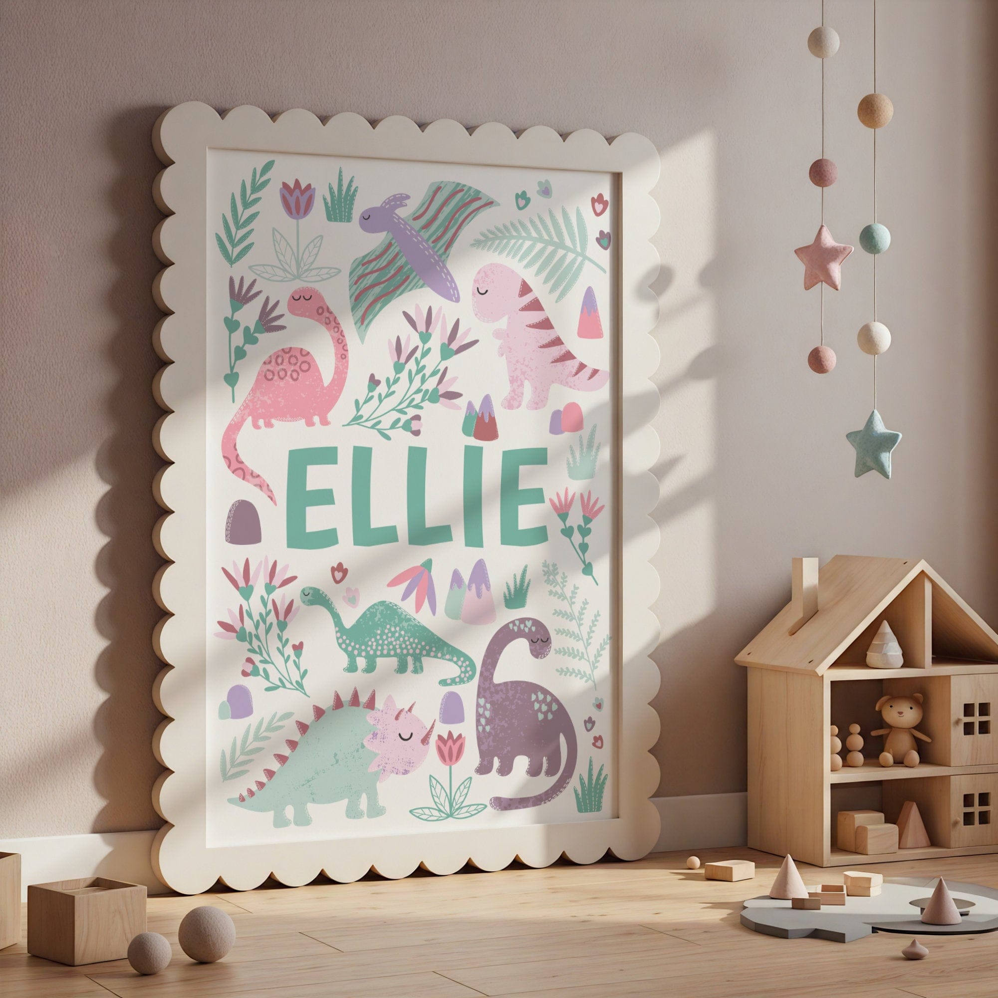 Children's room with a framed poster featuring colorful dinosaurs and the name 'ELLIE'.