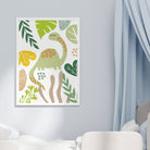 Close-up of a single green dinosaur print with bold leaves and abstract foliage on a pale wall.