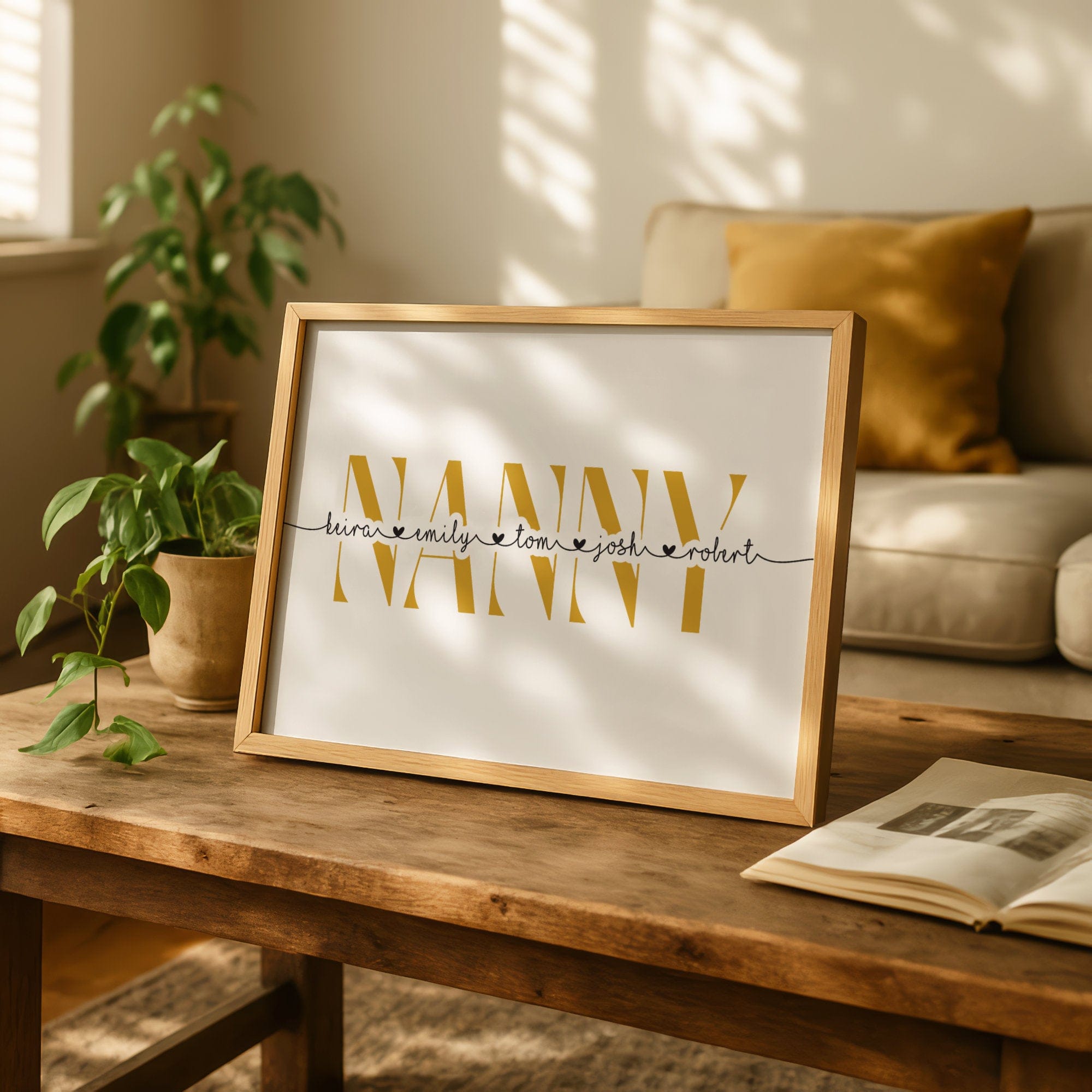 Framed artwork with 'NANNY' on a wooden table in a cozy living room.