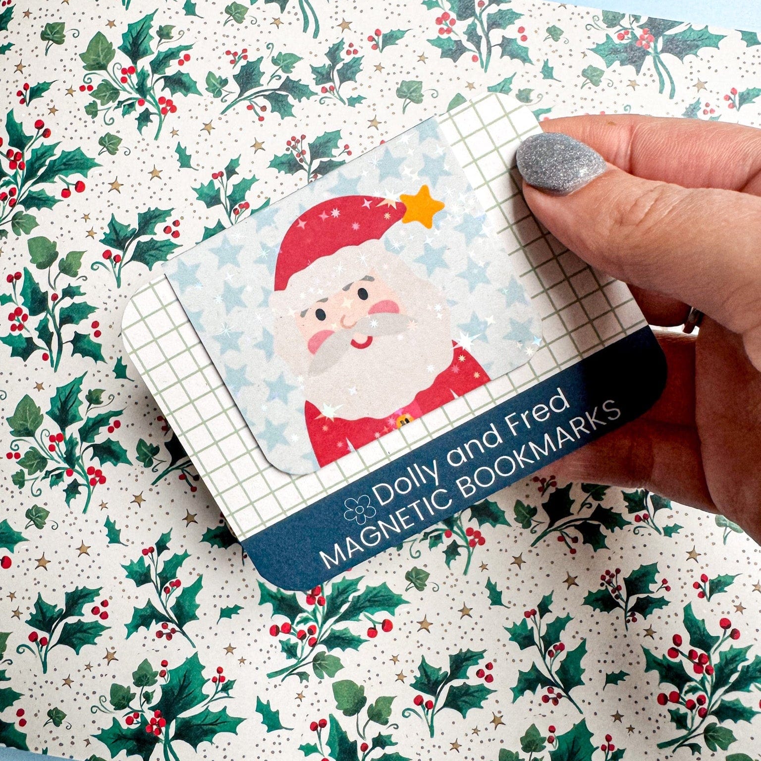 Magnetic bookmarks with Santa Claus design on a Christmas-themed fabric background
