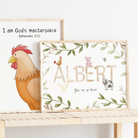 Two framed prints on a shelf with a rooster illustration and text, one named 'Albert'.