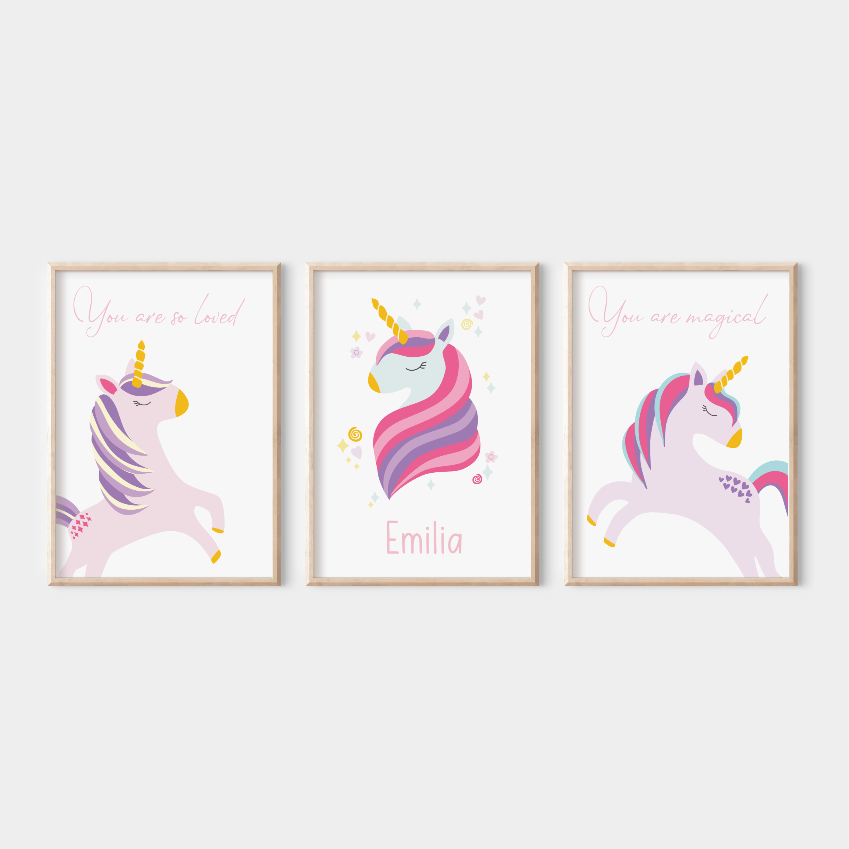 Set of 3 framed unicorn prints on a white wall – includes personalised name print and two affirmation prints with whimsical unicorn illustrations in soft pastel tones