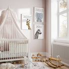 Three safari animal themed prints hanging on a nursery wall next to a crib