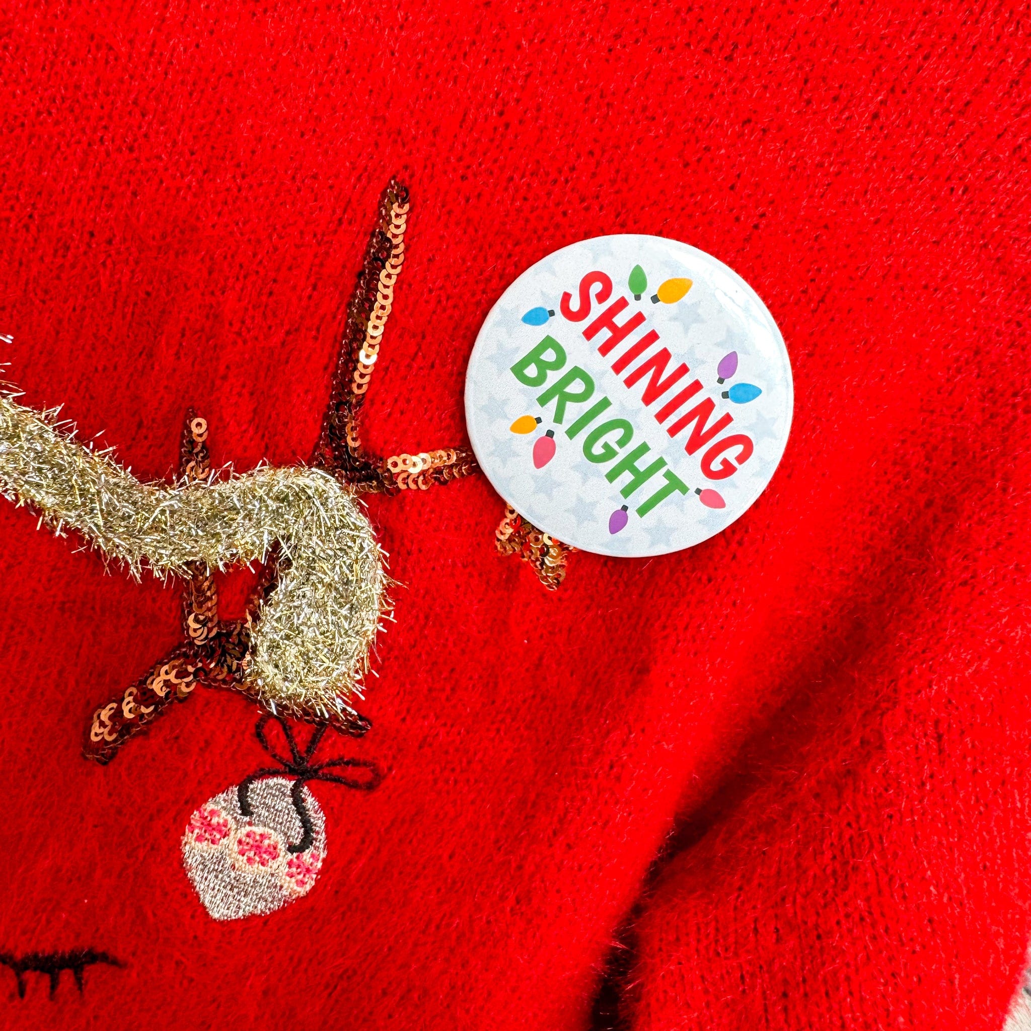 Shining bright badge on christmas jumper
