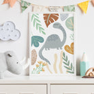 Framed dinosaur print with leaves on a shelf in a child's room