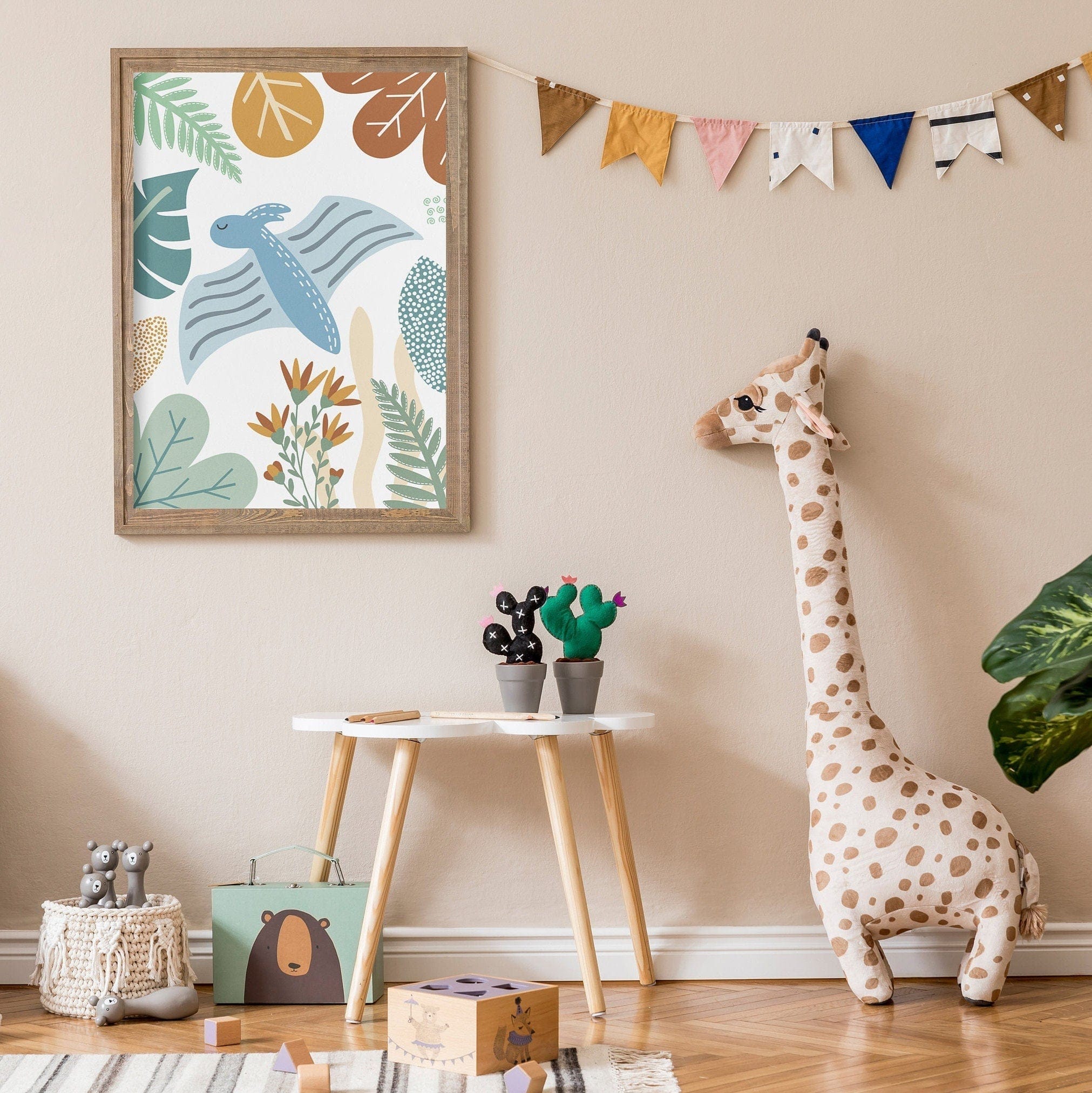 Children's room with a framed dinosaur artwork, a stuffed giraffe, and decorative items on a beige wall.