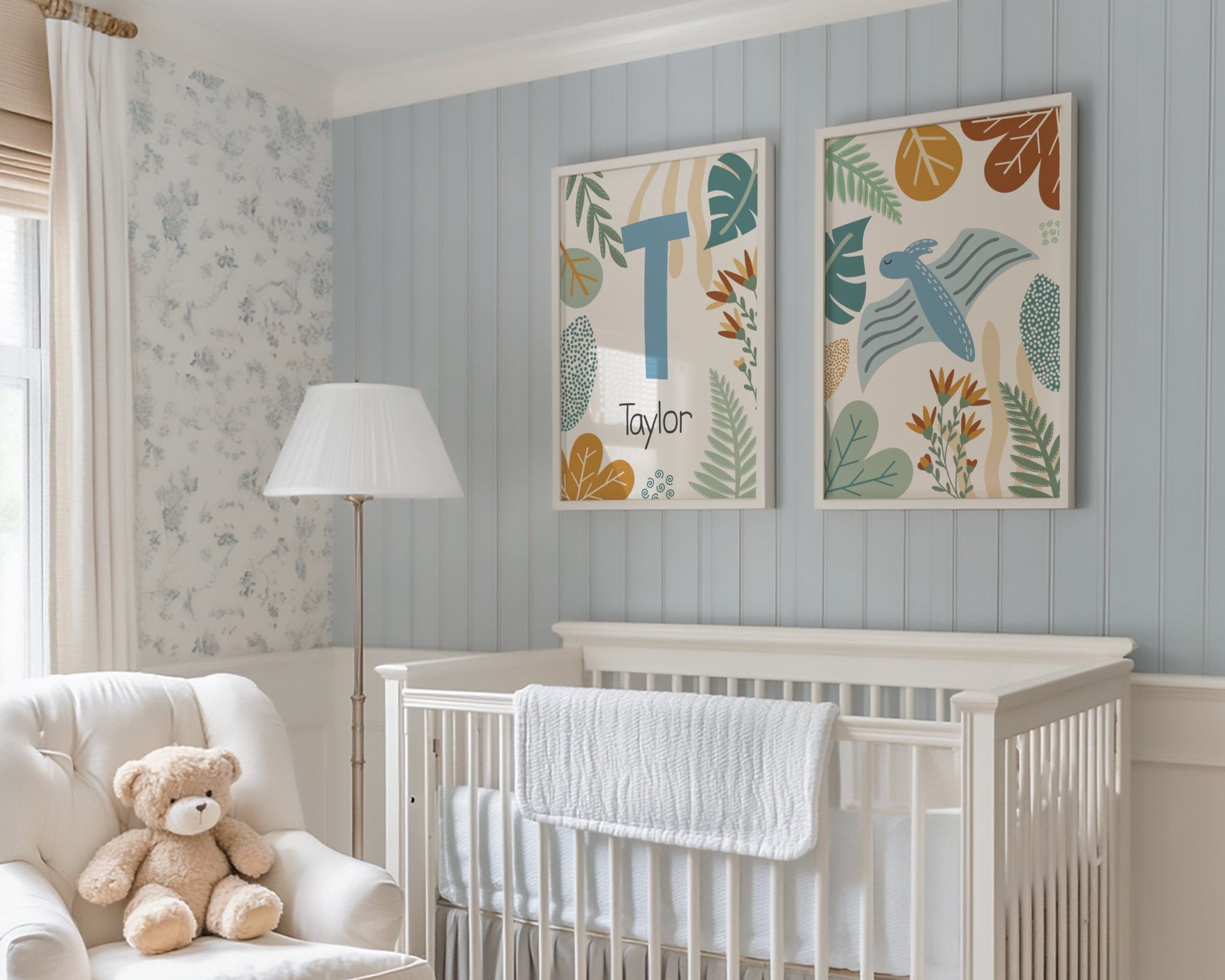 Nursery room with a crib, chair, teddy bear, and decorative dinosaur wall art.