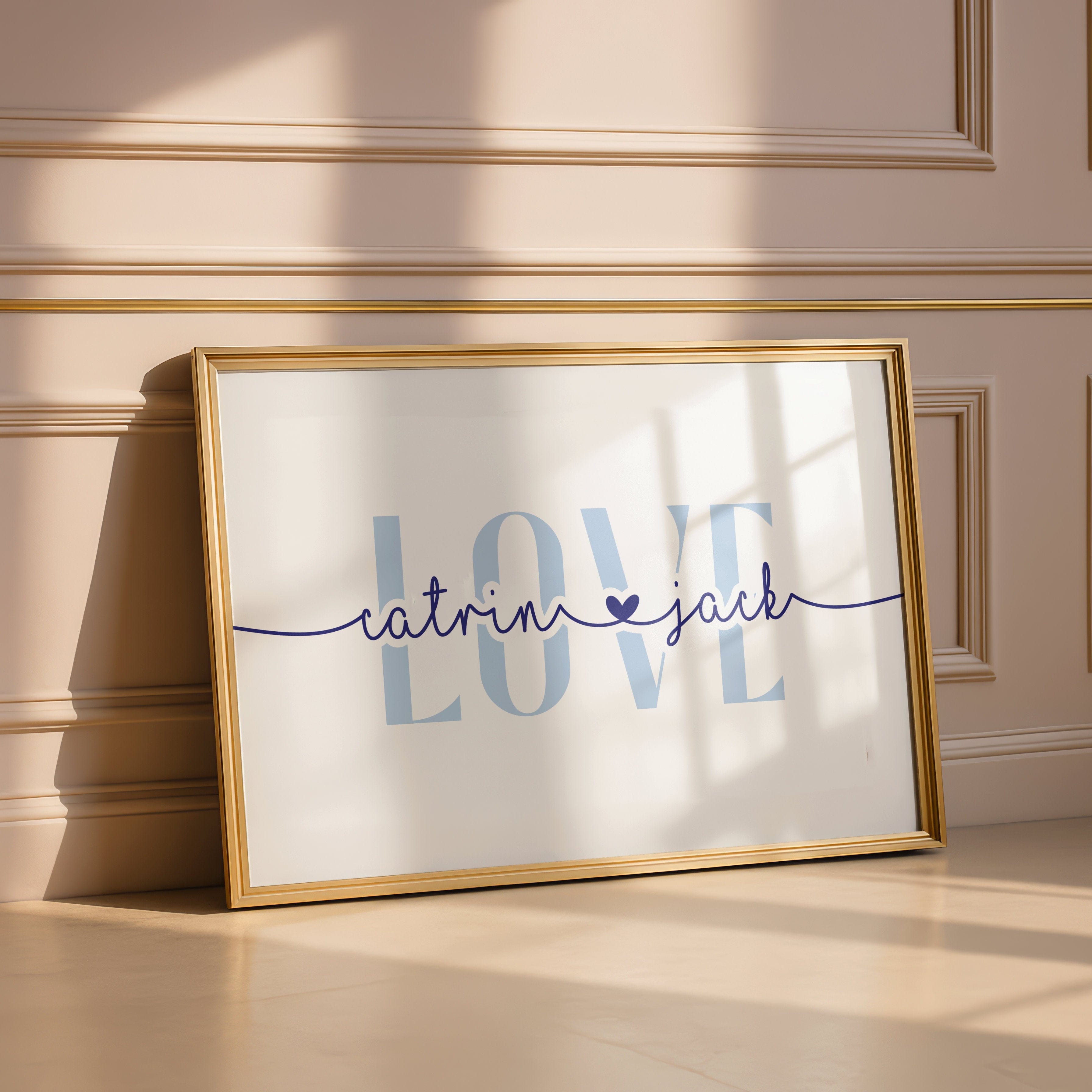 Framed artwork with 'LOVE catrin jack' text on a wall.