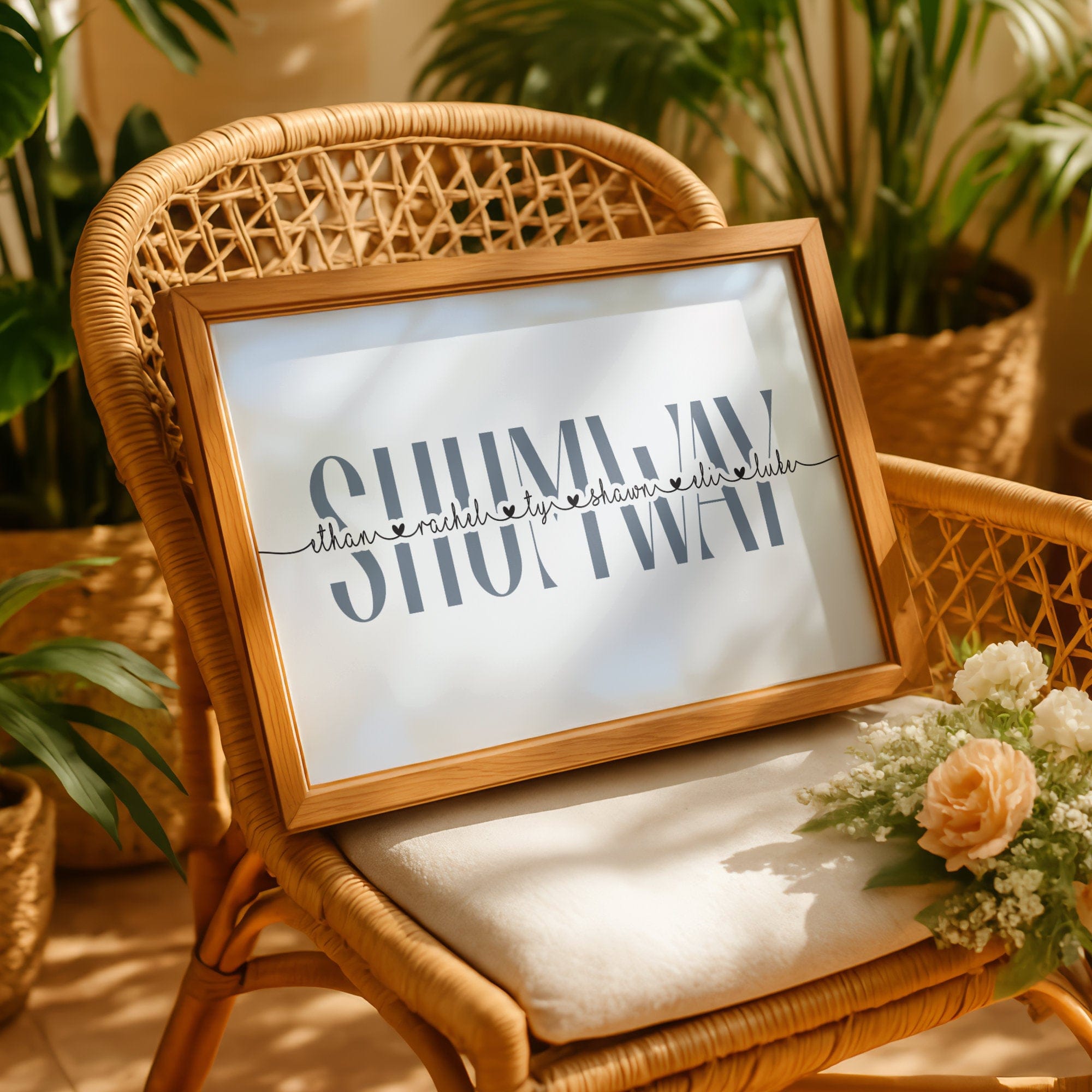 Framed family name sign on a wicker chair with plants in the background