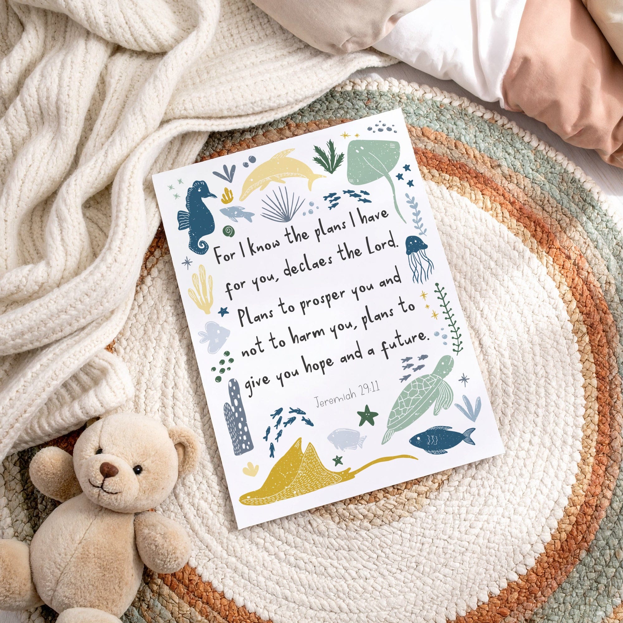 Print with ocean-themed illustrations and text on a textured surface with a teddy bear.