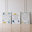 Three framed prints with biblical verses and illustrations on a wooden floor.