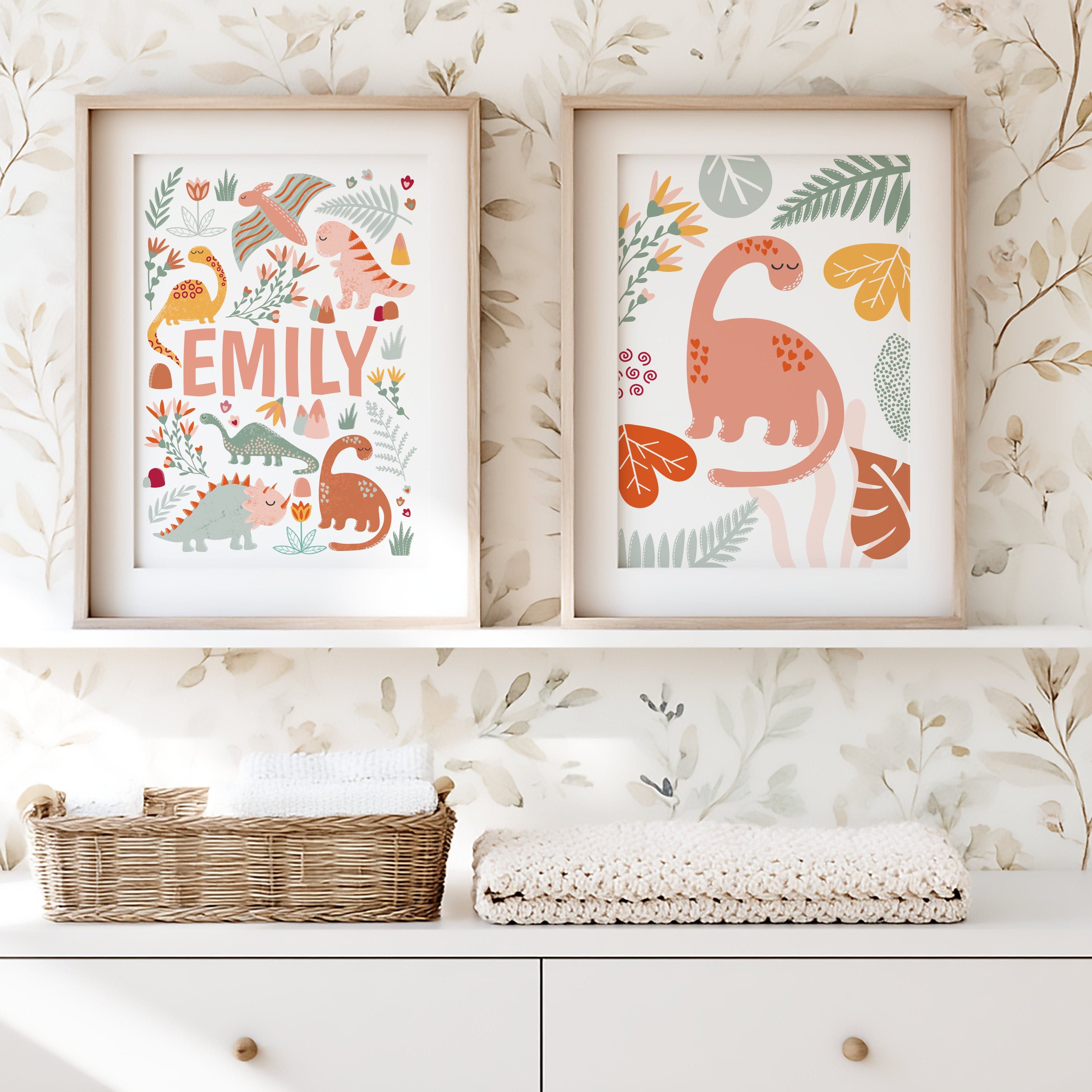 Two framed prints with dinosaur illustrations on a wall with floral wallpaper.