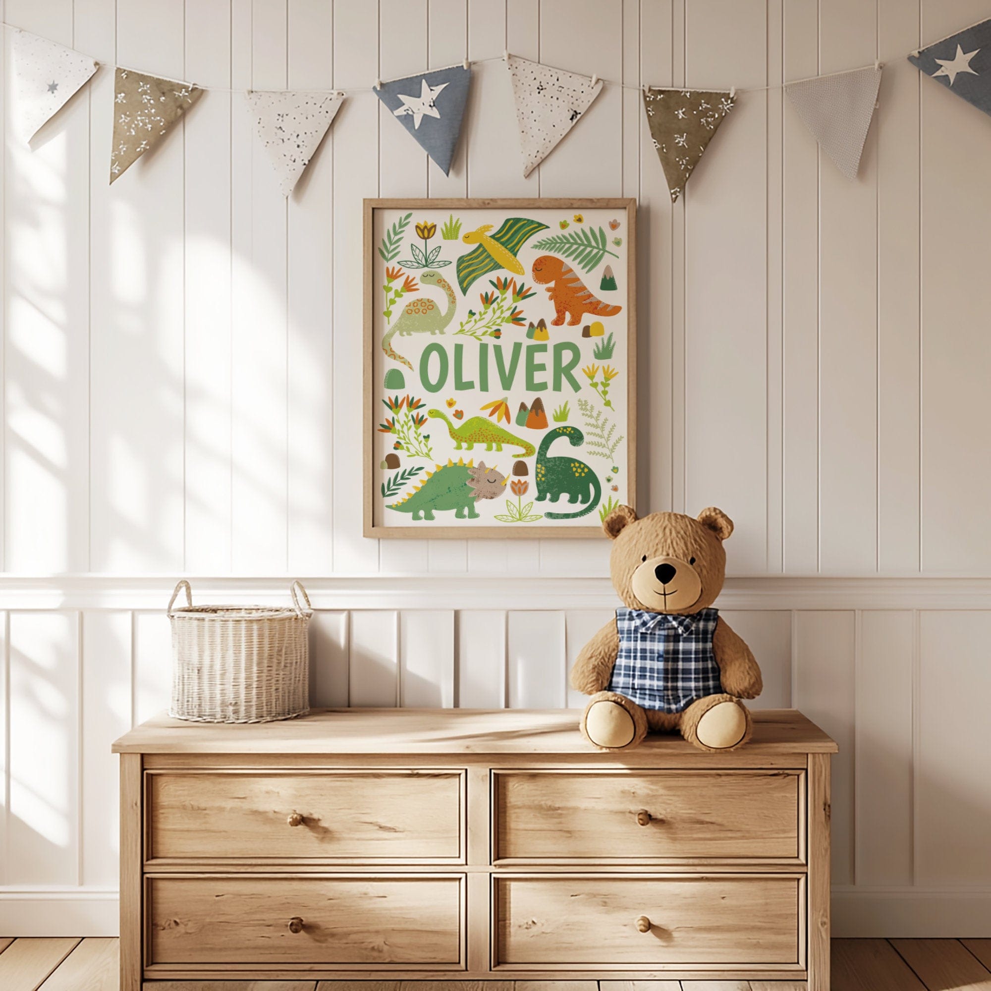Wooden dresser with teddy bear, basket, and framed dinosaur print in a child's room.