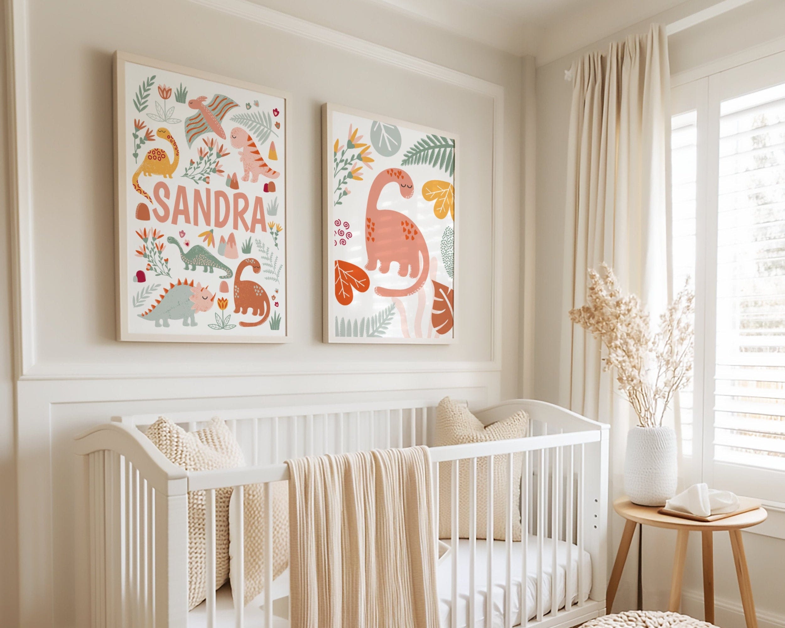Nursery room with a white crib, decorative pillows, and wall art featuring dinosaurs.