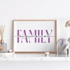 Framed artwork with 'family' text on a white surface with decorative items.