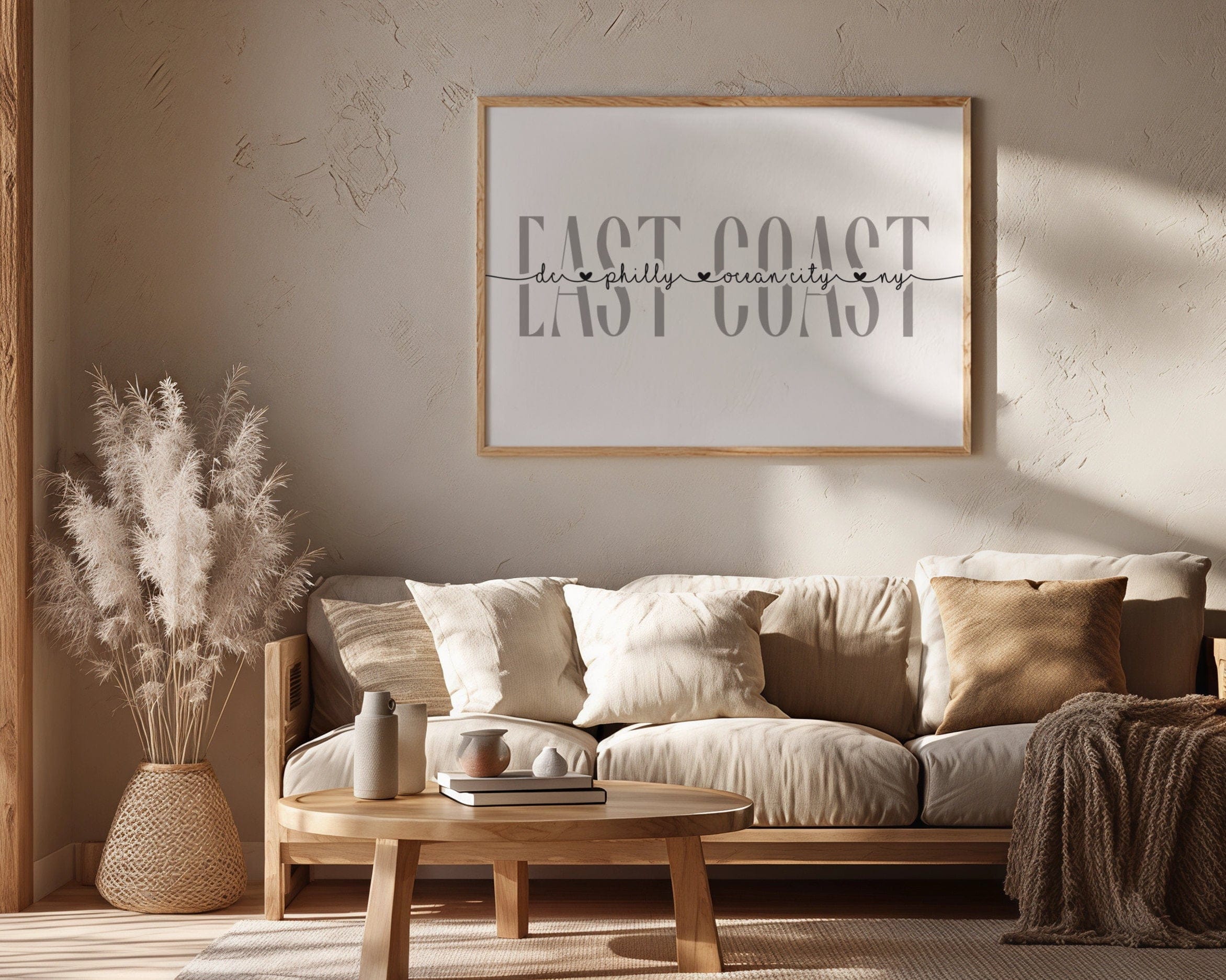 Living room with a beige sofa, wooden coffee table, and framed artwork on the wall.