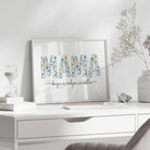 Framed artwork with 'MAMA' and floral designs on a white desk.