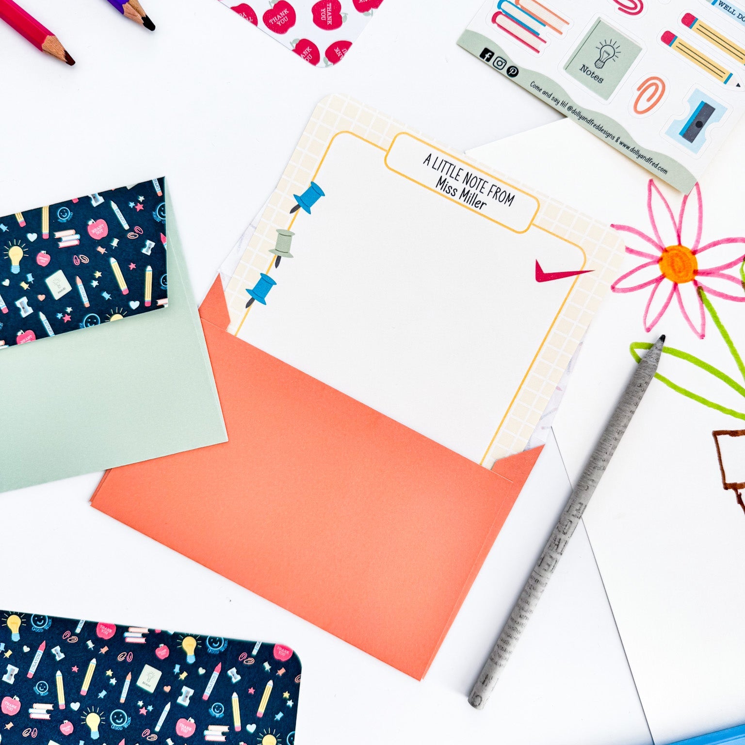 Open orange envelope displaying children's letter and writing paper contents.