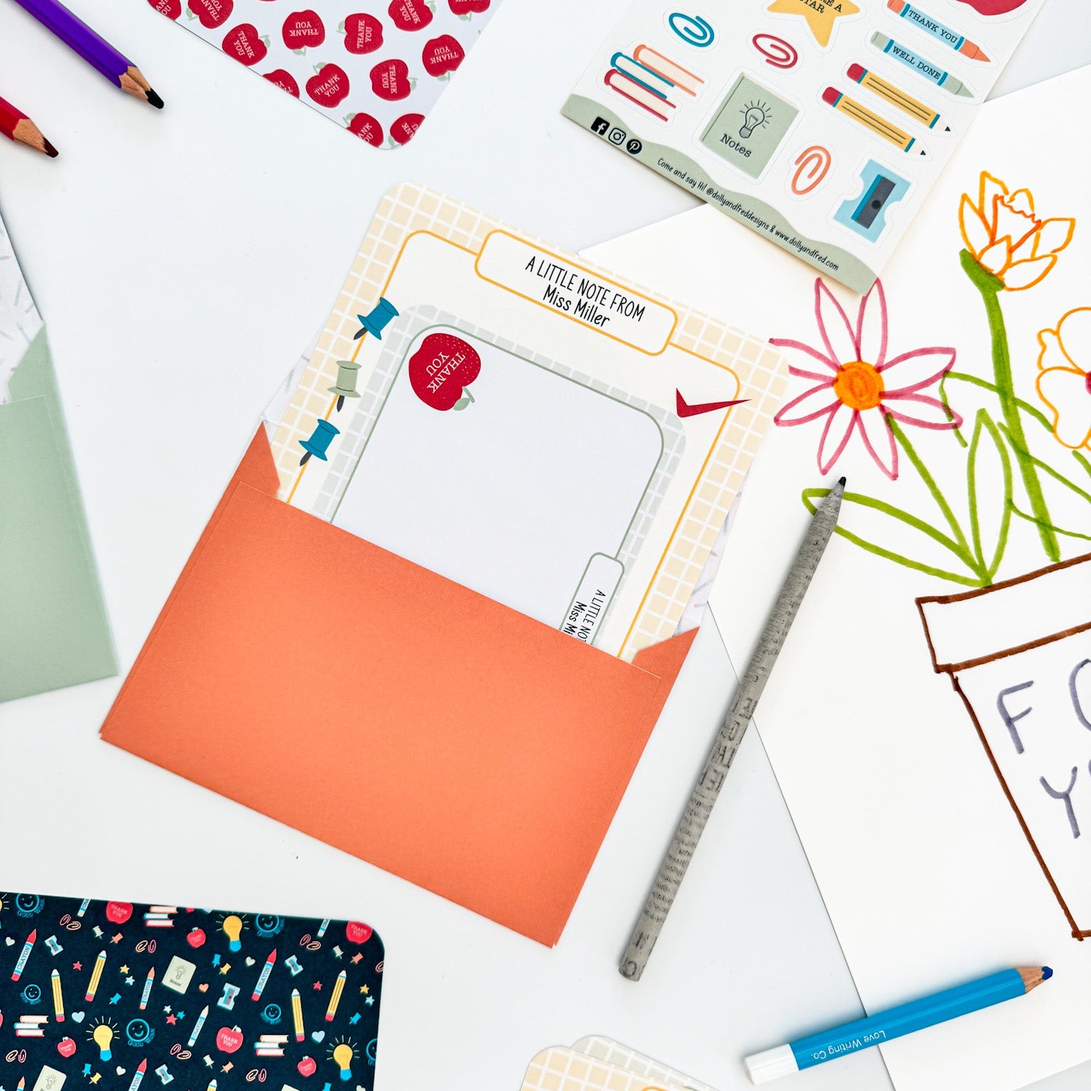 Flat lay showing writing paper, matching envelopes, and sticker sheet from the set.
