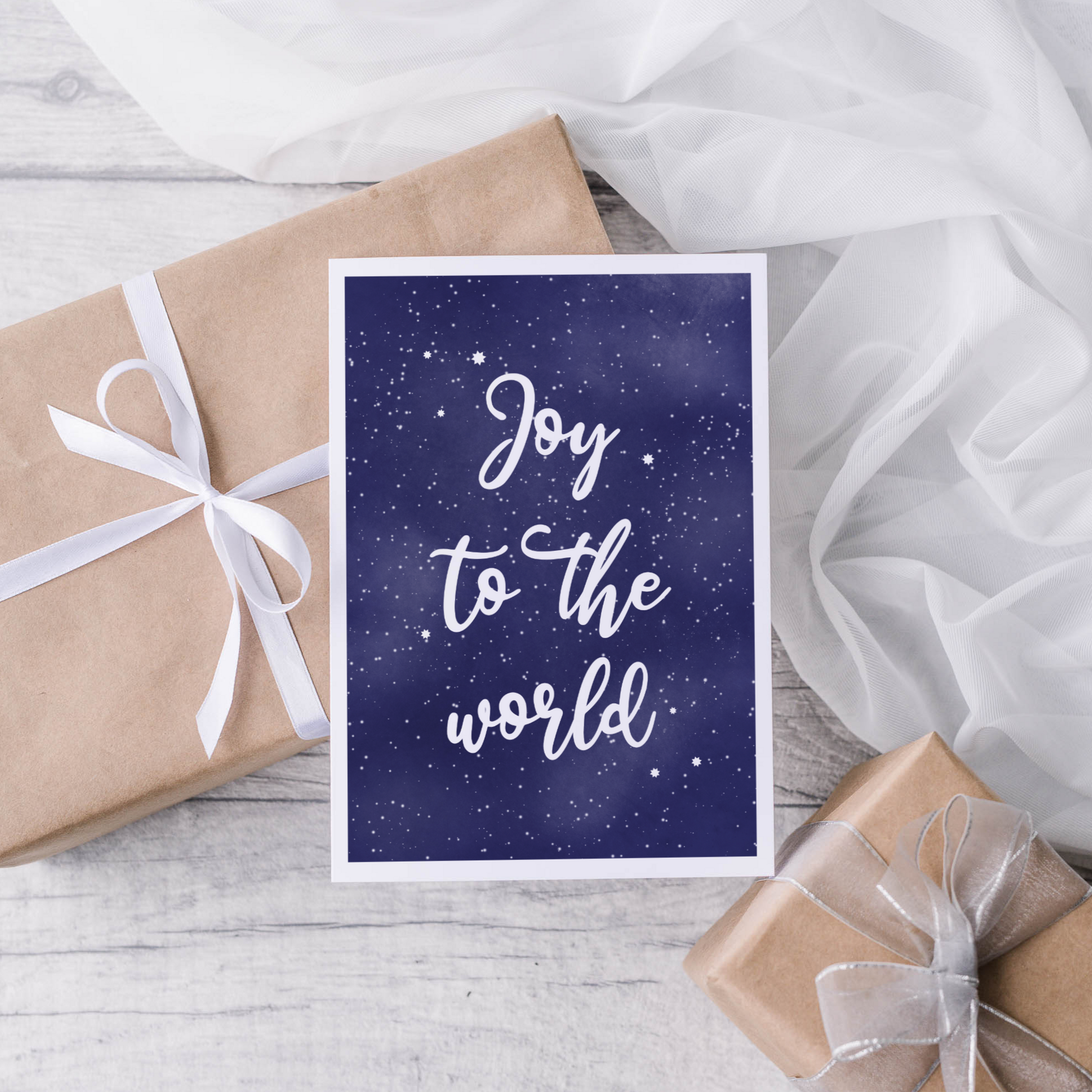 Text Joy to the world in white set against a night sky background with white border