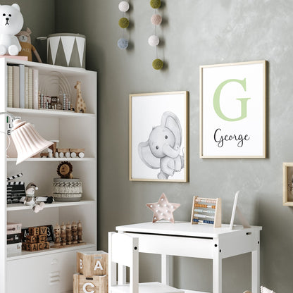 Monochrome elephant print with a light green monogram print next to it hung on a playroom wall