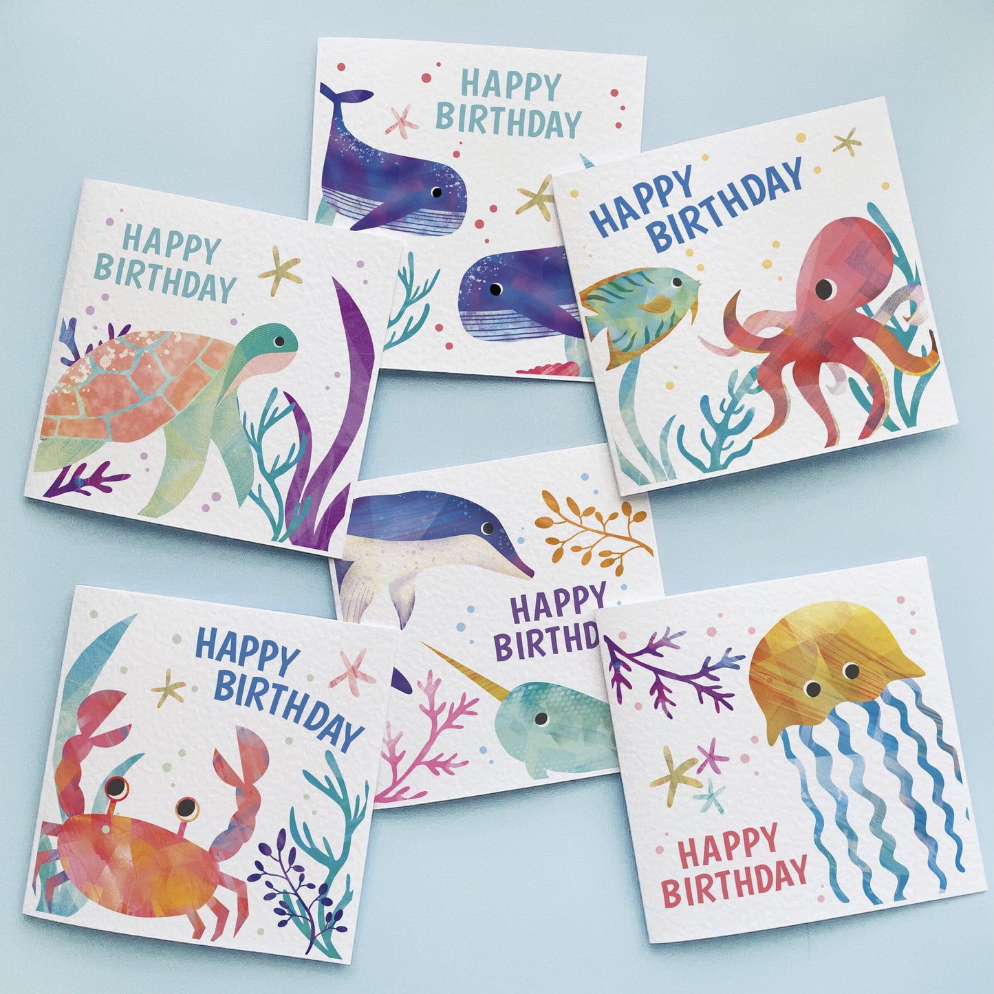 Adorable underwater scene with colorful fish and birthday cake illustration on a kids' sea themed birthday card.